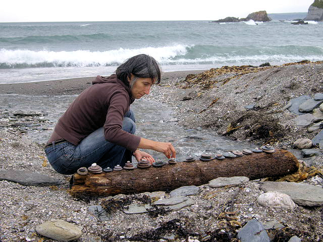 Emma on the seashore arranging stones