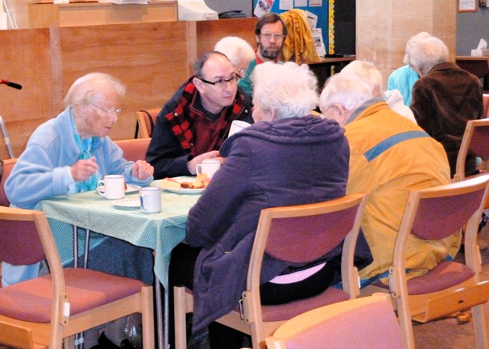 Group having tea and cakes after the service