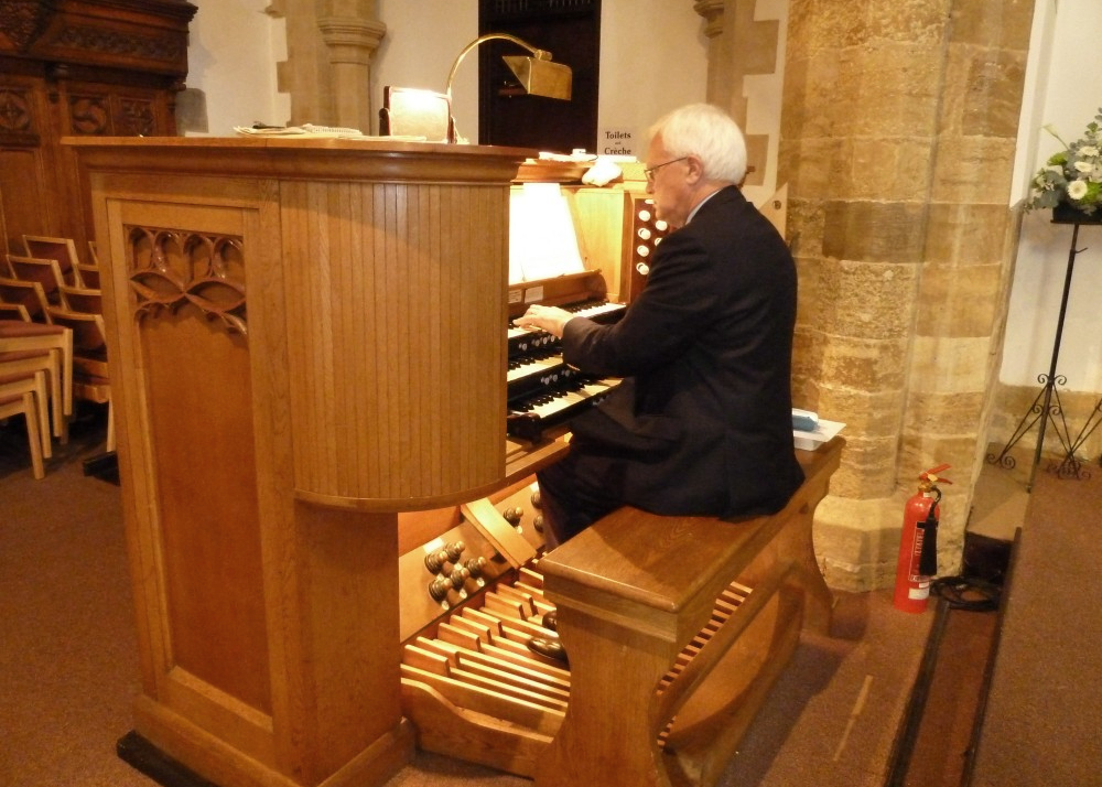 Organist playing the St Giles organ at a Hymns of Praise service